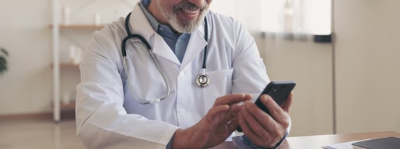 Doctor looking at cell phone
